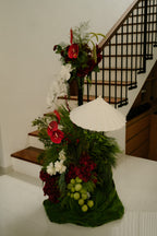Decorative floral arrangement with a white umbrella on a staircase